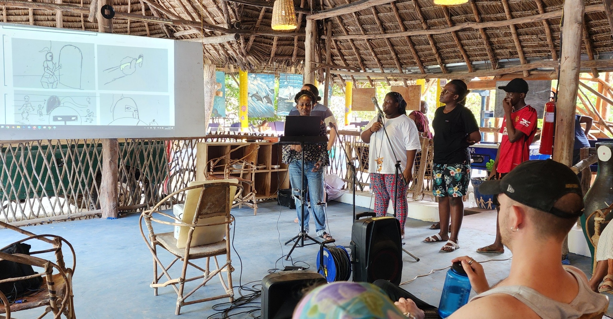 A facilitator presenting animation drawings